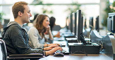 man sitting at computer